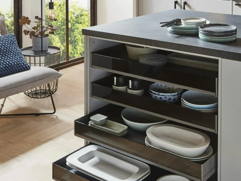 Neatly arranged dishes in kitchen shelving.