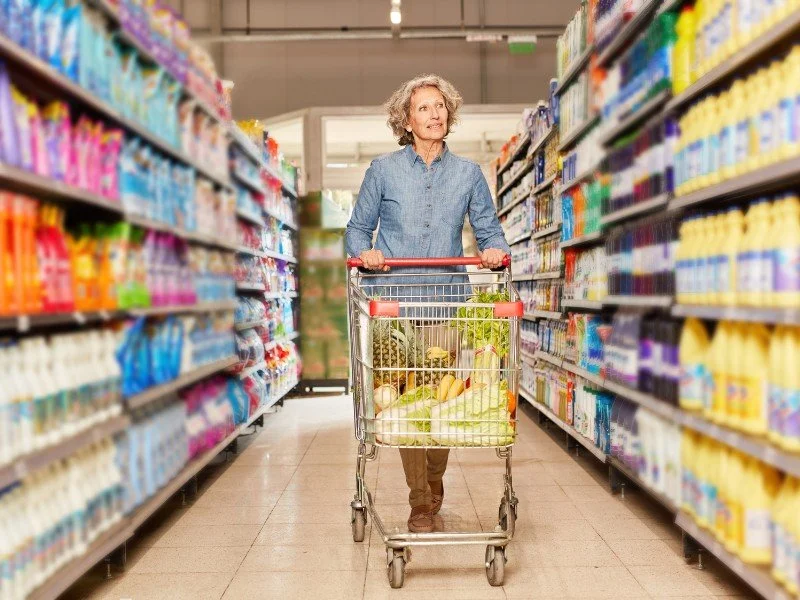 Shopping groceries in a supermarket aisle.