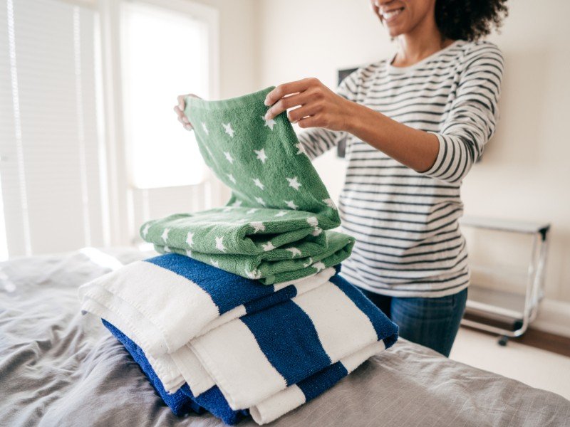 Folding laundry, maintaining cozy home vibes.