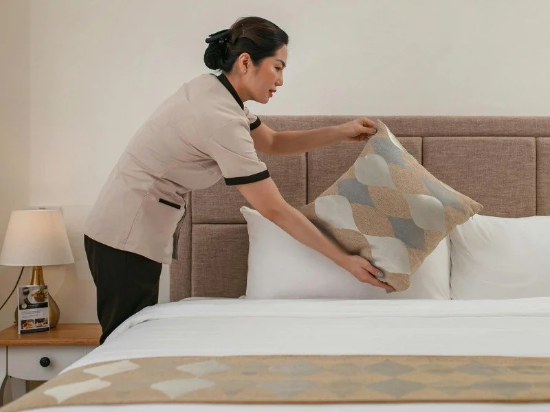 Bed making, creating a cozy retreat.