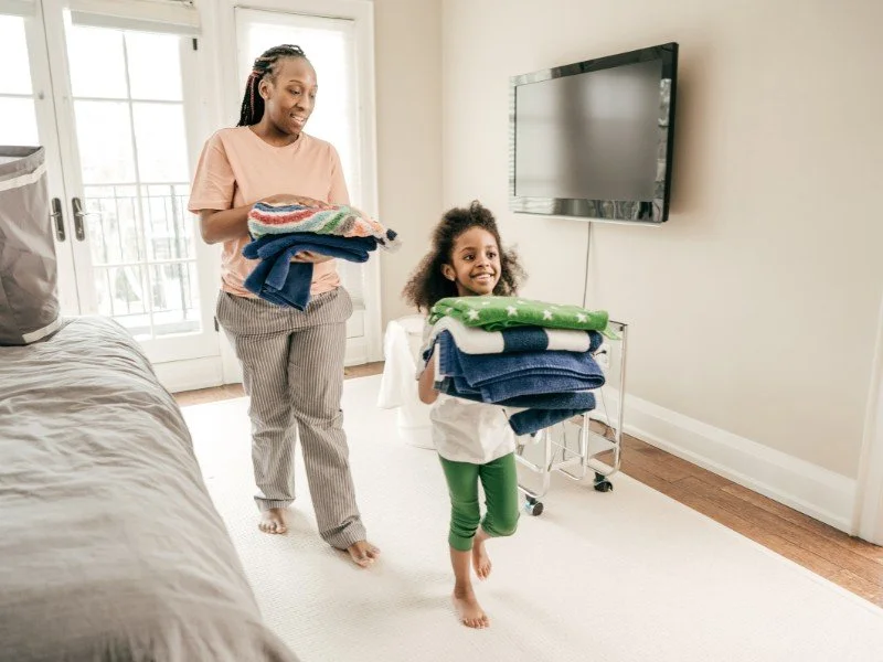 Teamwork in chores, folding with love.