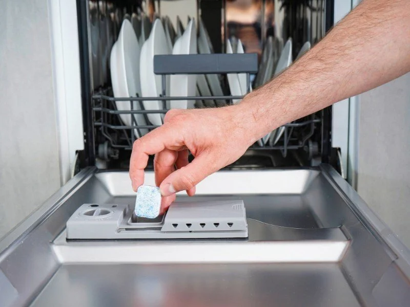 Adding detergent, preparing for wash.