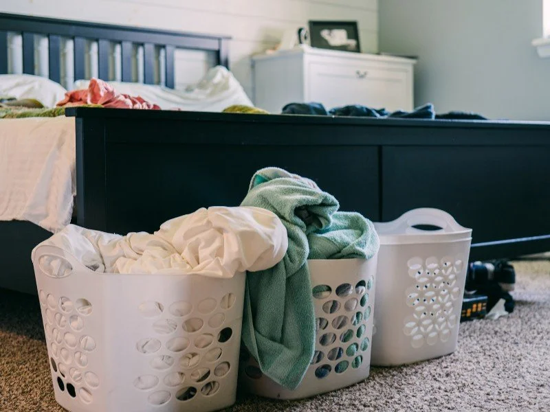 Laundry baskets full, awaiting folding time.