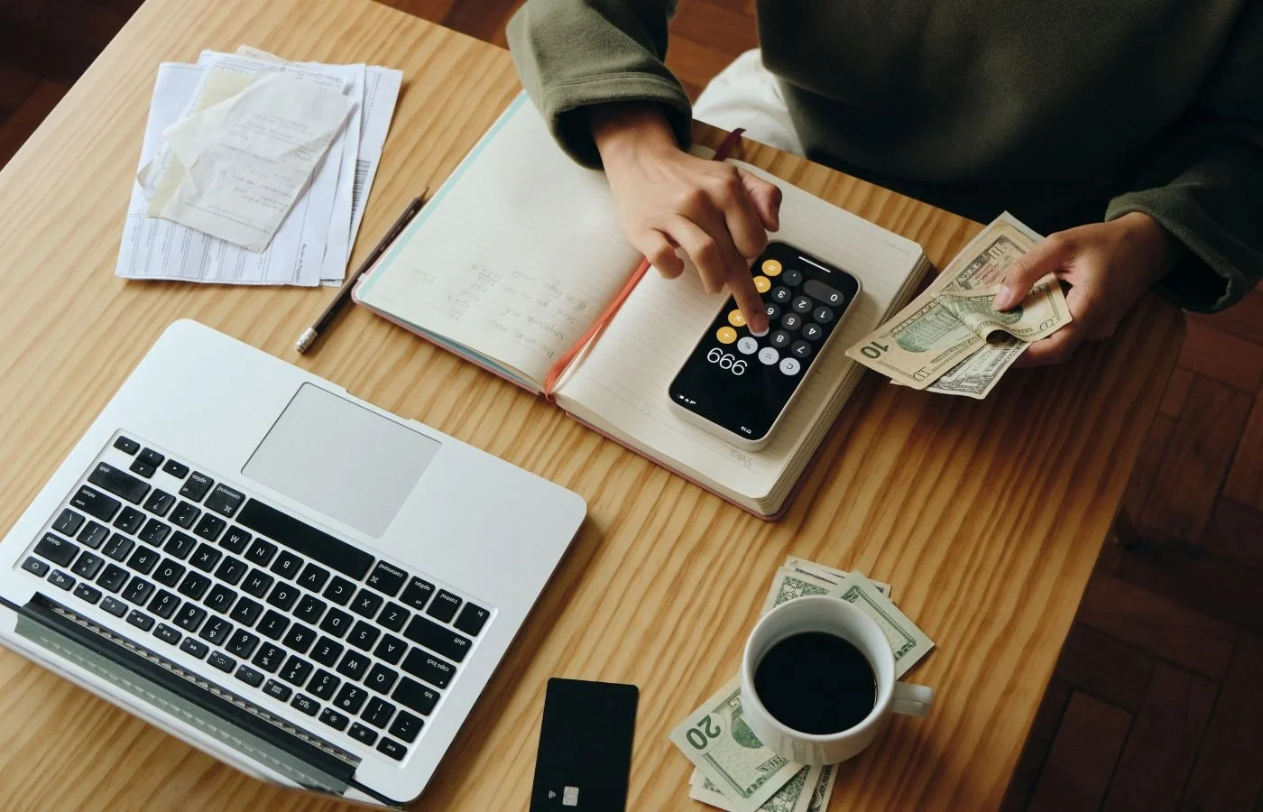 Person budgeting with cash, calculator