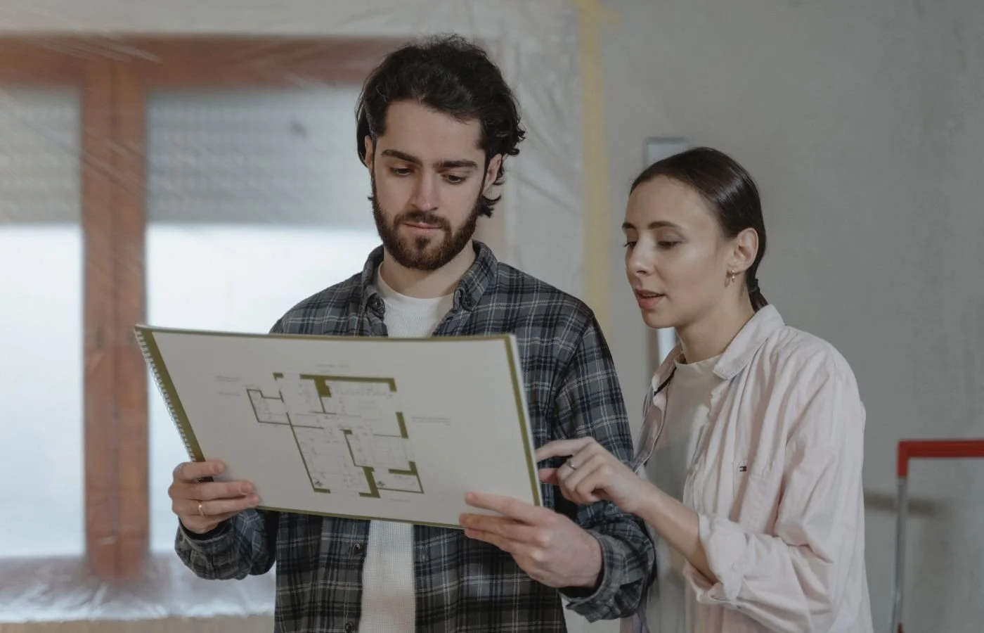 Couple reviewing house plan for home preparedness