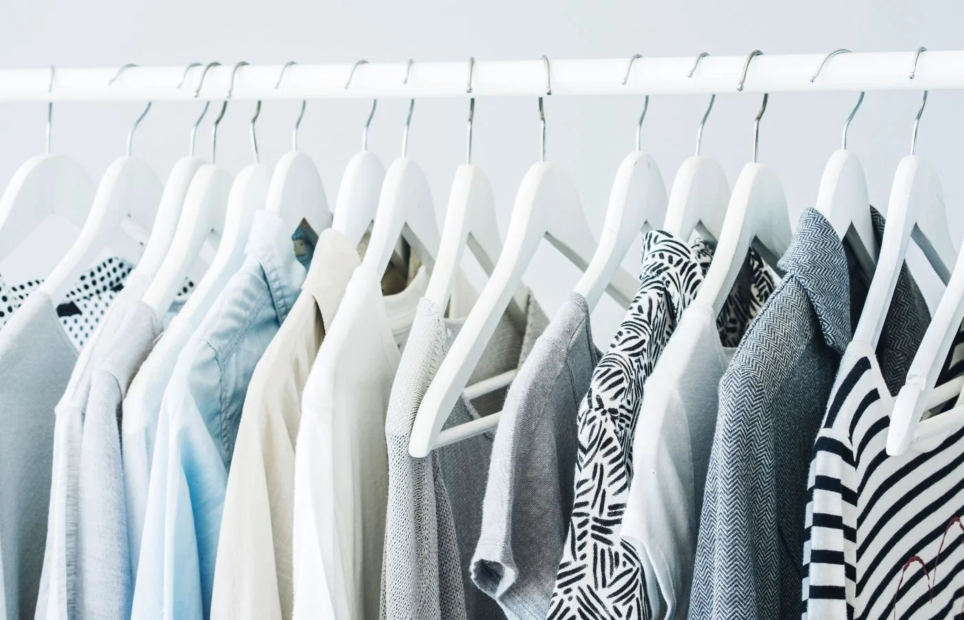 Neatly organized clothes on hangers.