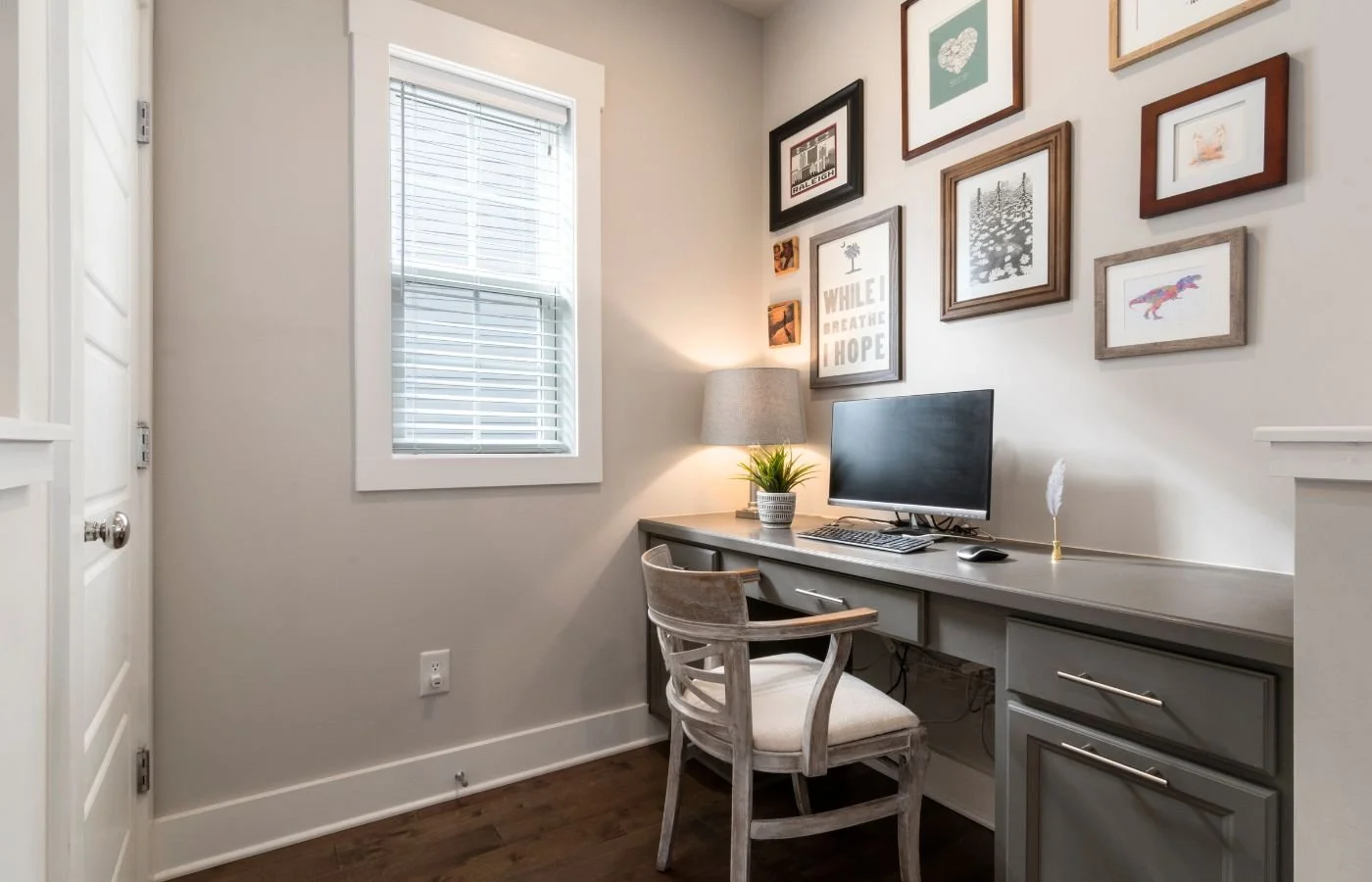 Home office with desk and wall art