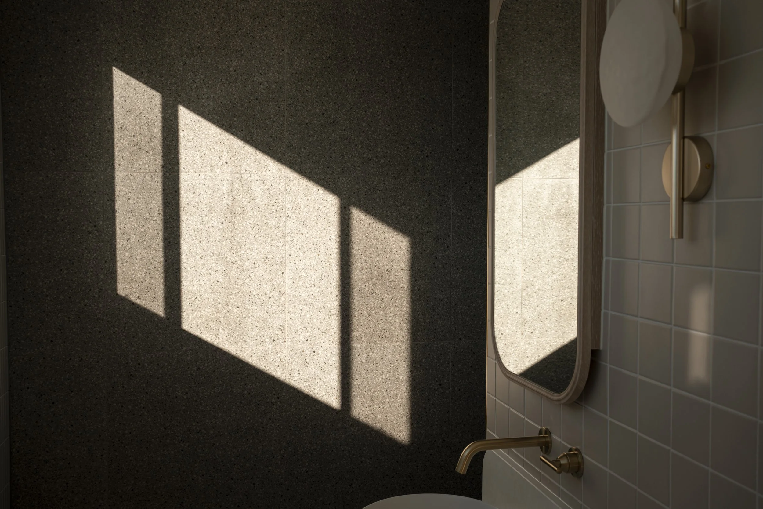 Bathroom with a mirror, tiled wall, and a window casting a rectangular shadow on the wall. Architecture photography Gold Coast by Joey Bailey