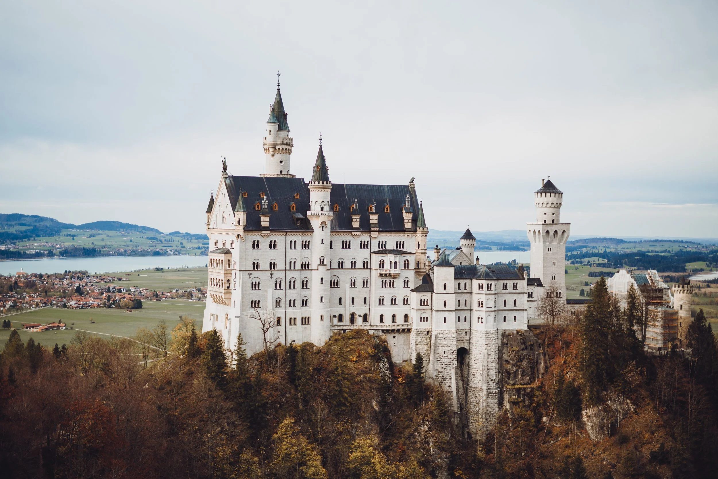 Neuschwanstein Castle in Germany surrounded by trees and hills