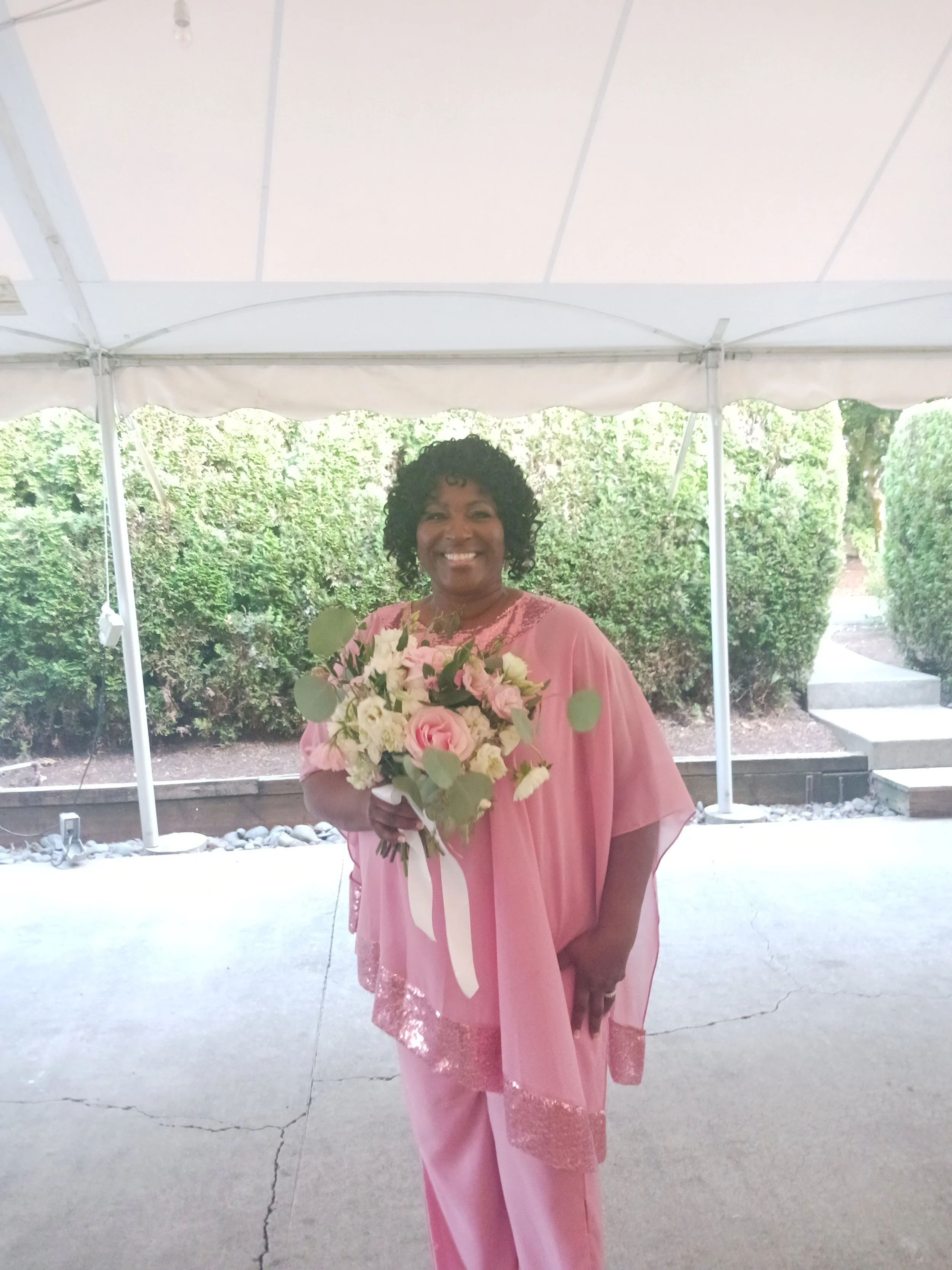 Minister Felicia caught the Bride's Wedding Bouquet