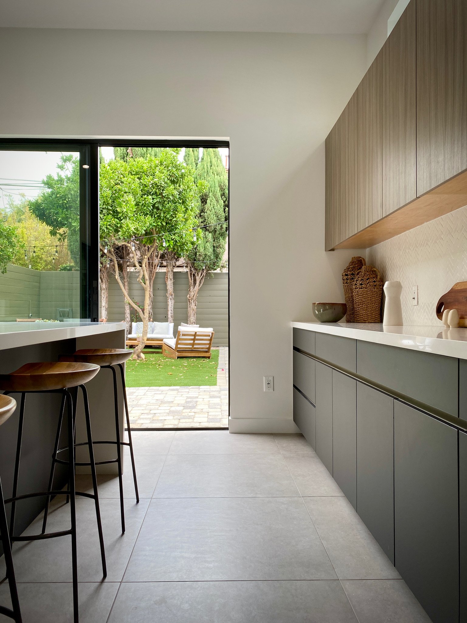 The opposite side of the kitchen island features a buffet counter and more storage