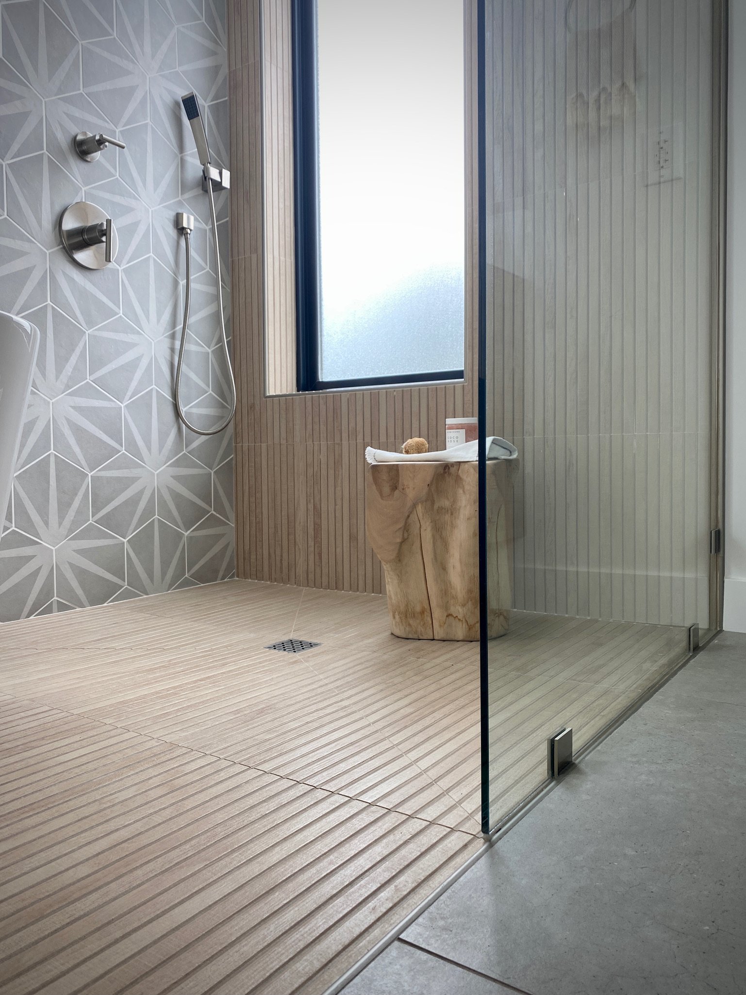 The shower floor and bathroom floor are curbless.