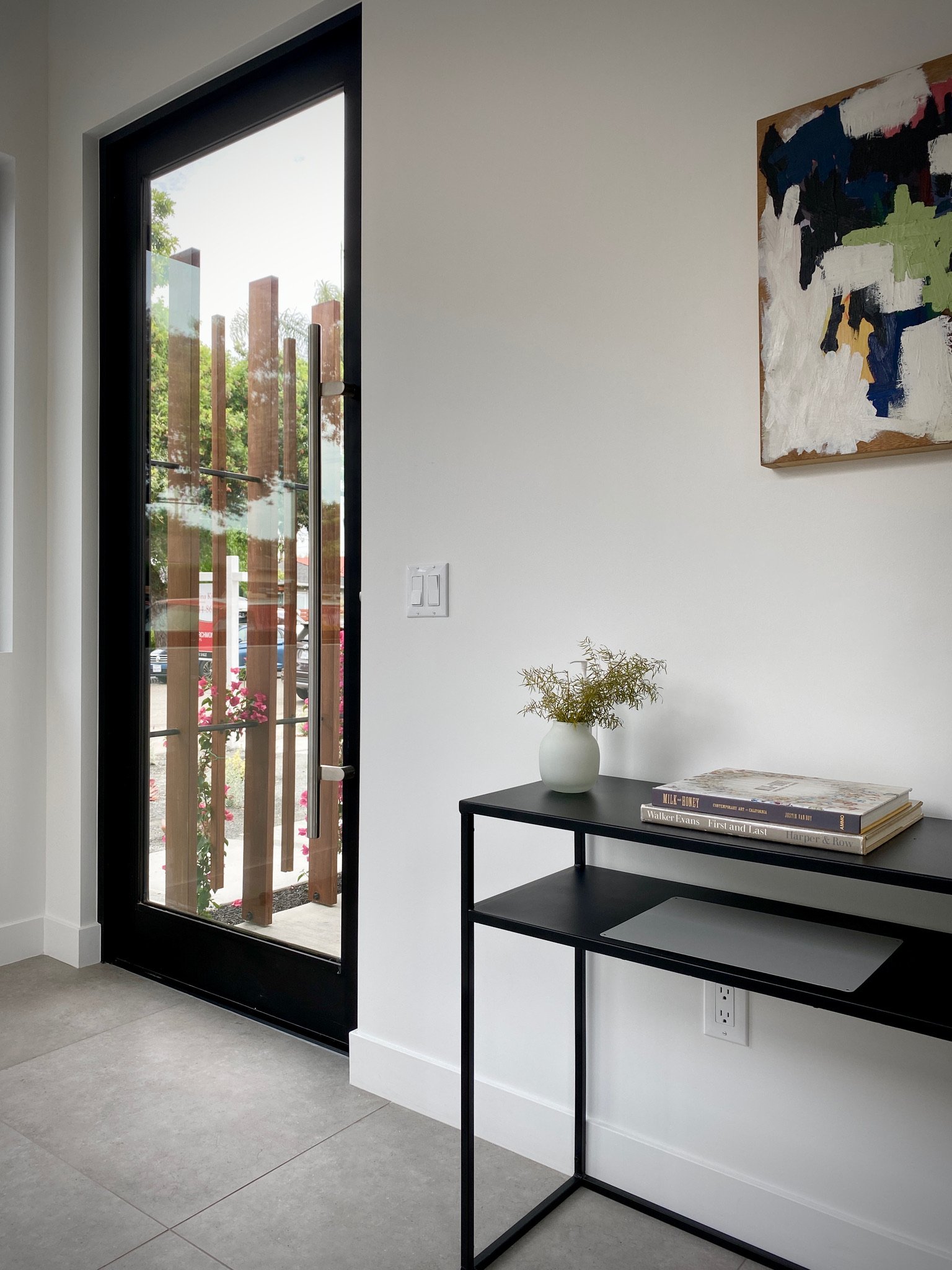 The front door is screened off from the street for privacy.