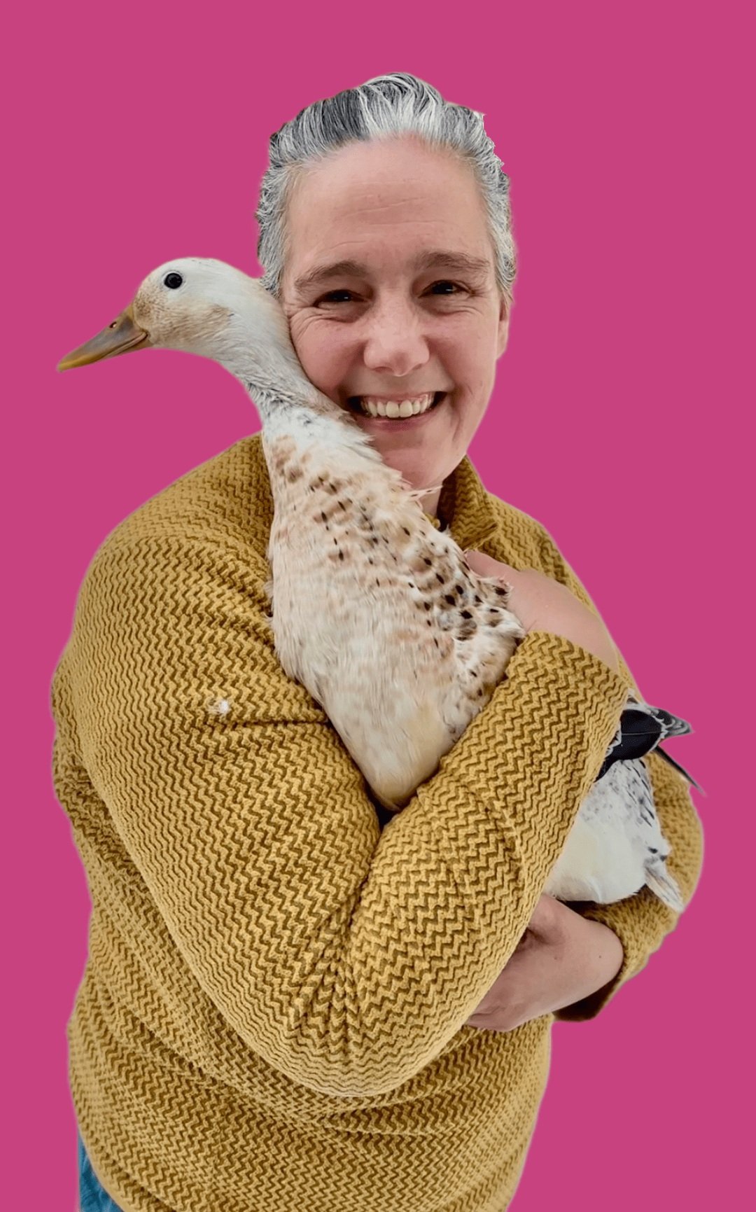 Elle Odyn smiling and holding a duck in the forest garden.