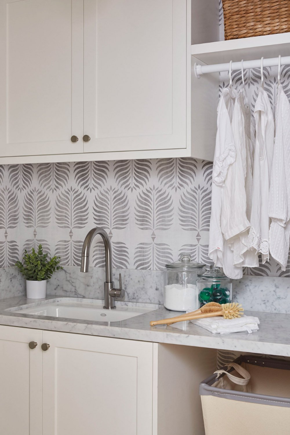 White and grey patterned wallpaper in linen room.jpg