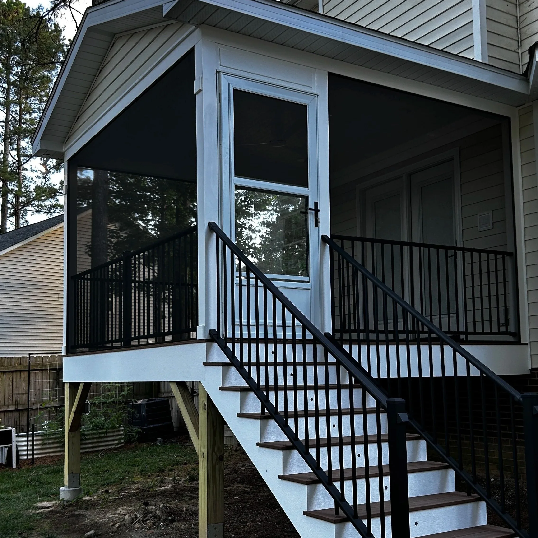 12 x 12 screen porch completed in Wendell, NC. Project includes high quality composite decking, aluminum rails, and PVC throughout. PVC ceiling cladding, column wraps, and perimeter framing. This project also includes our low-voltage kit a beautiful 