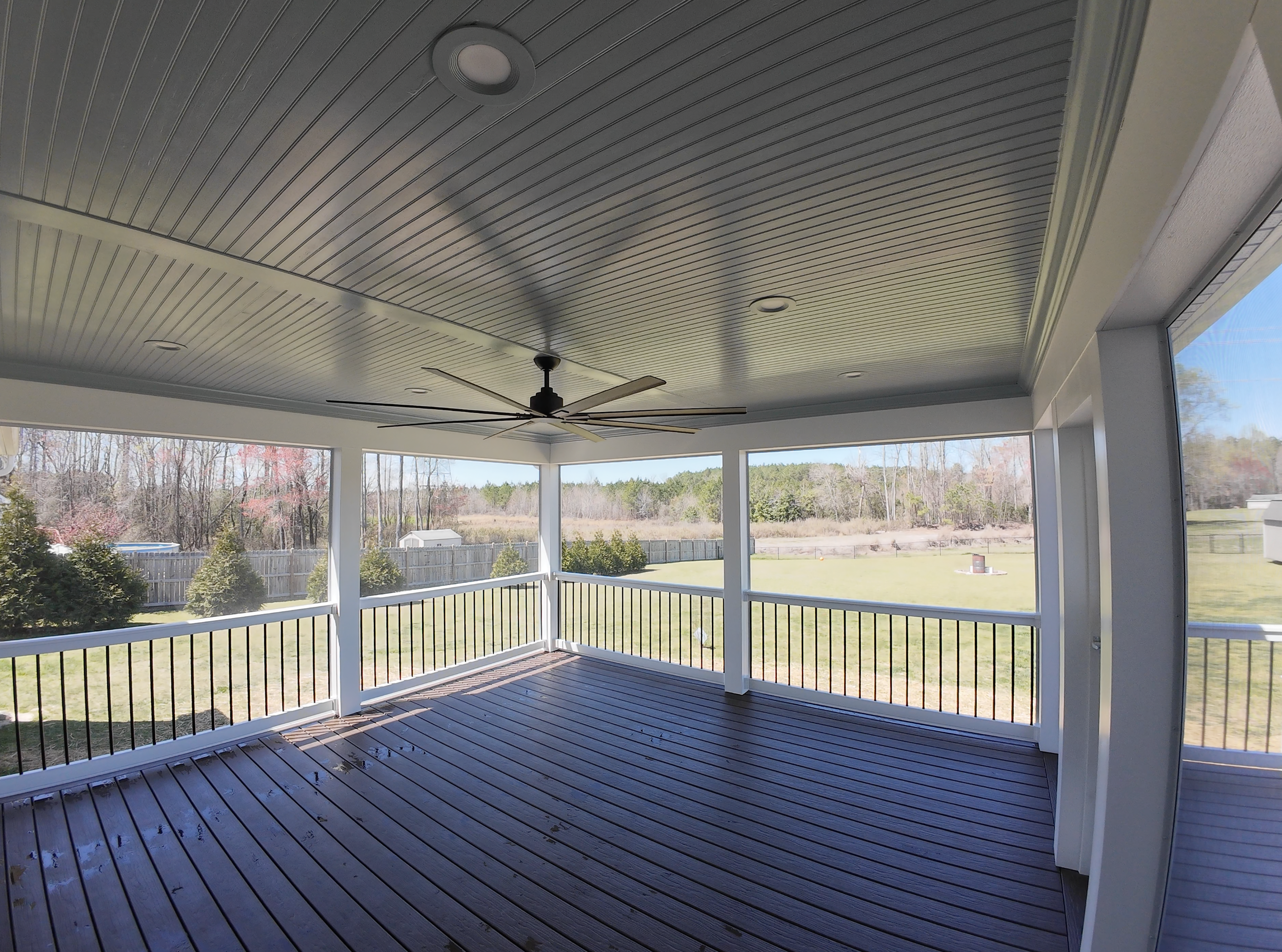 Stogner Porch & Grilling Deck: Moisture Shield Vision (Cold Brew) | ScreenEZE in White | RDI T-Top Railing with Black Round Balusters | Full PVC Wrap | Plybead ceiling in "Haint Blue"