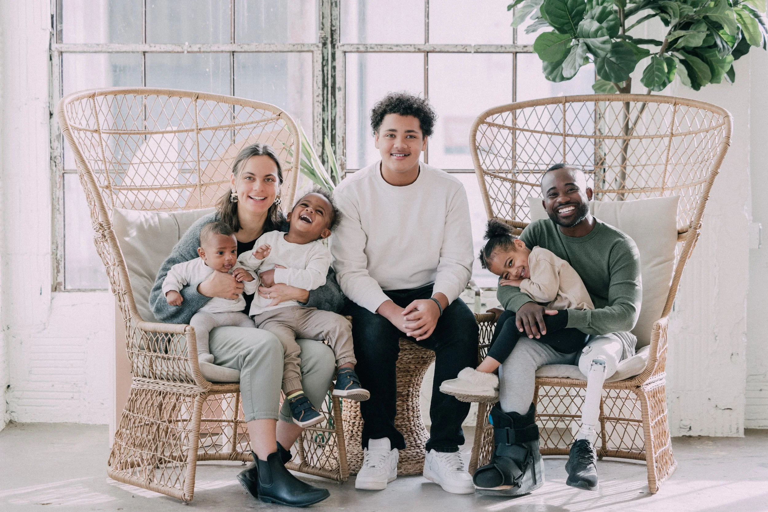 A family sitting down taking family photos