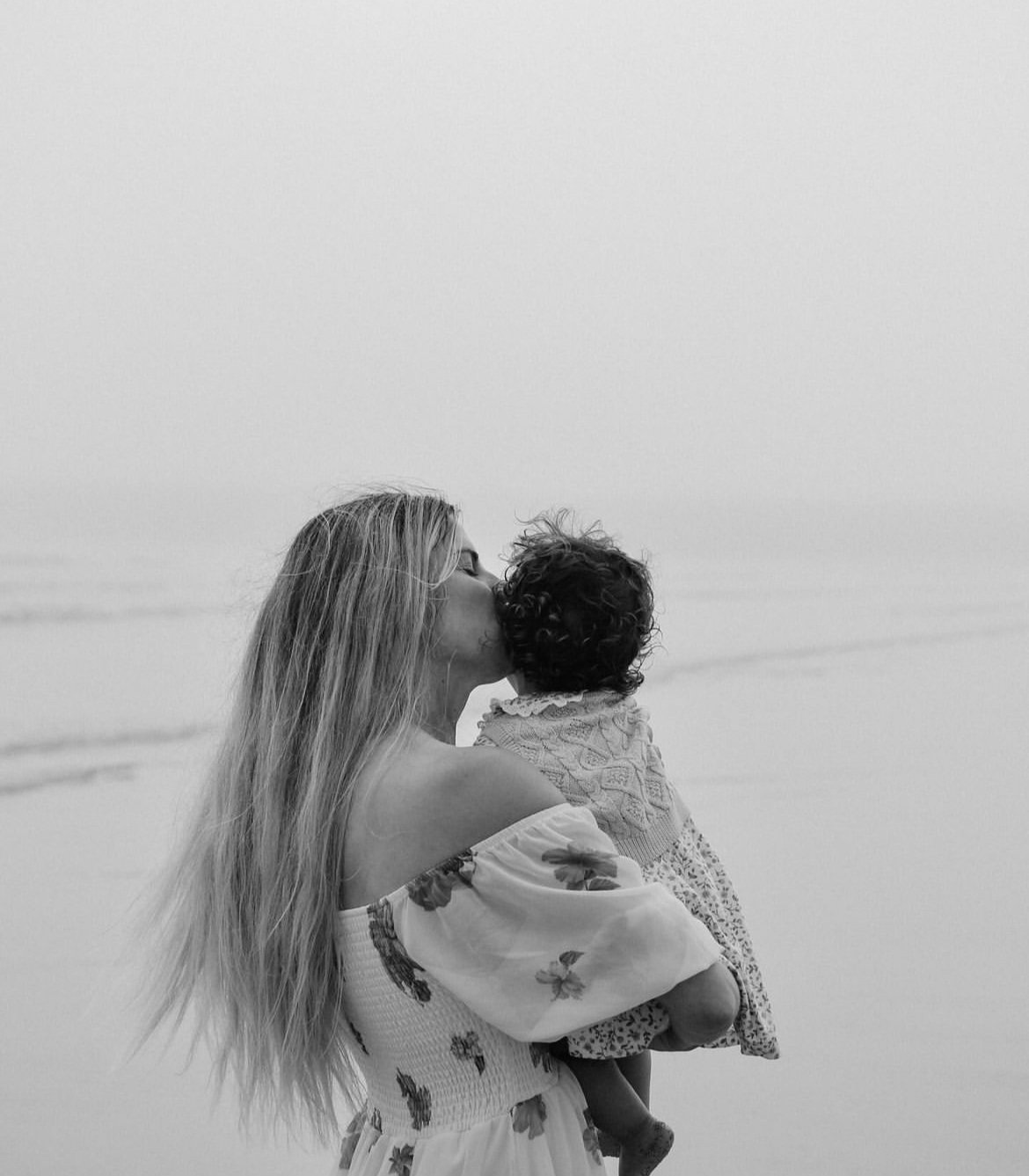 New mom holding baby and kissing head