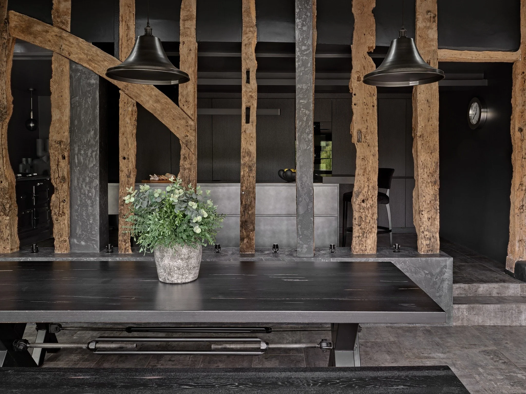 When the building is this special, the kitchen has to be brave.

We leaned into the drama of this 15th-century Essex barn, and designed a space that is genuinely unique. 

dark kitchens, dramatic kitchen design, alternative barn kitchen