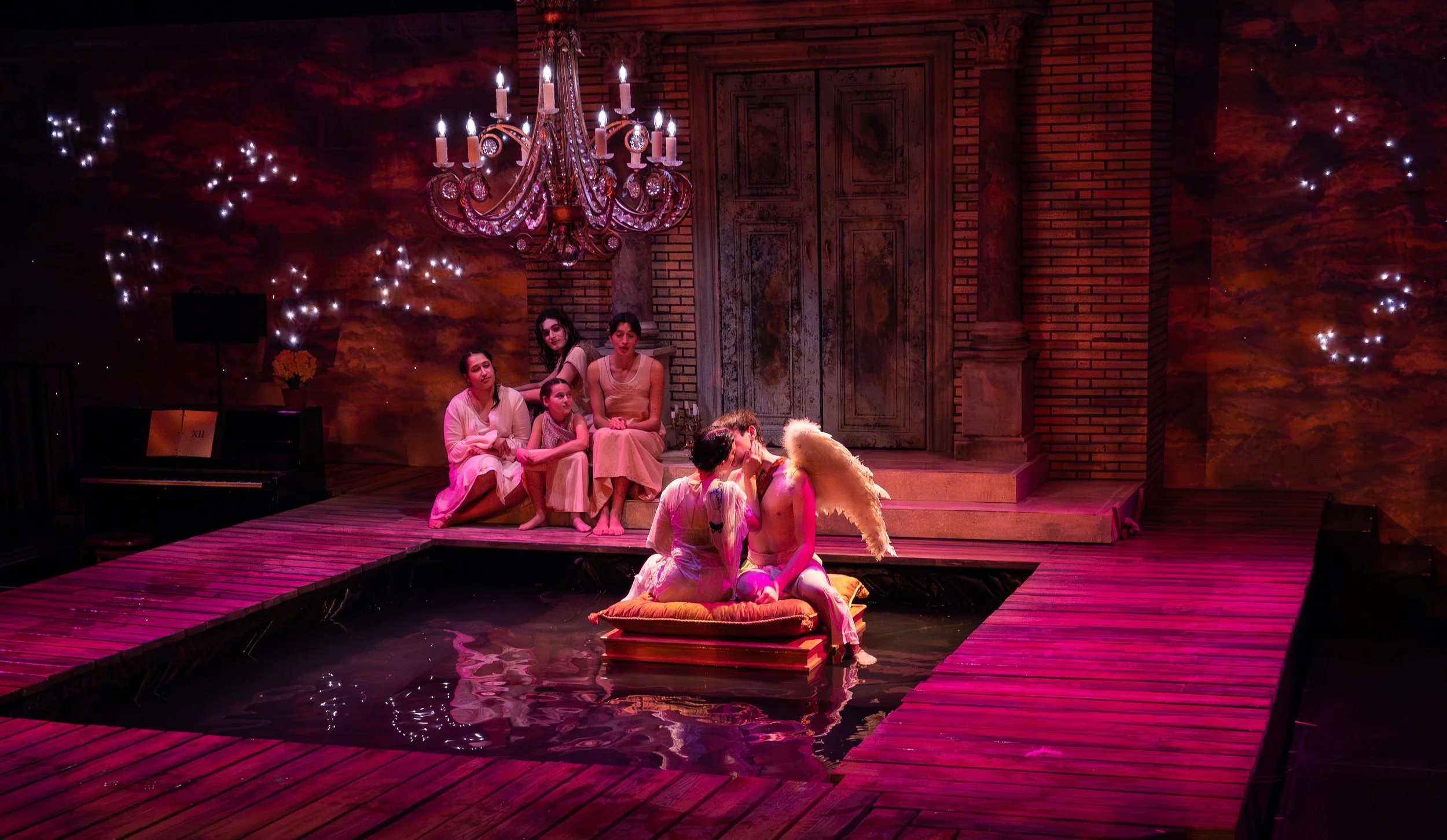 Eros and Psyche kissing on a raft while watched by a small group.