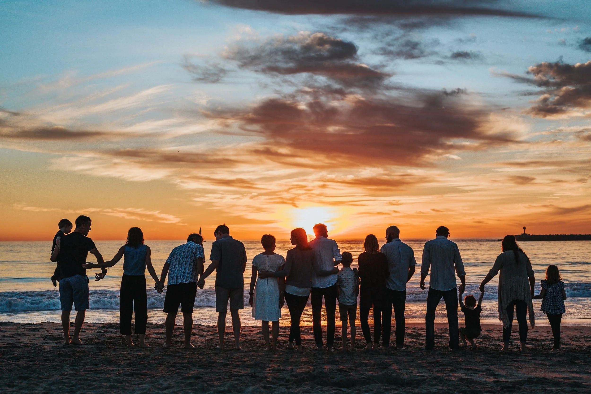 Extended family on the beach representing how genetics and lifestyle influence long-term health