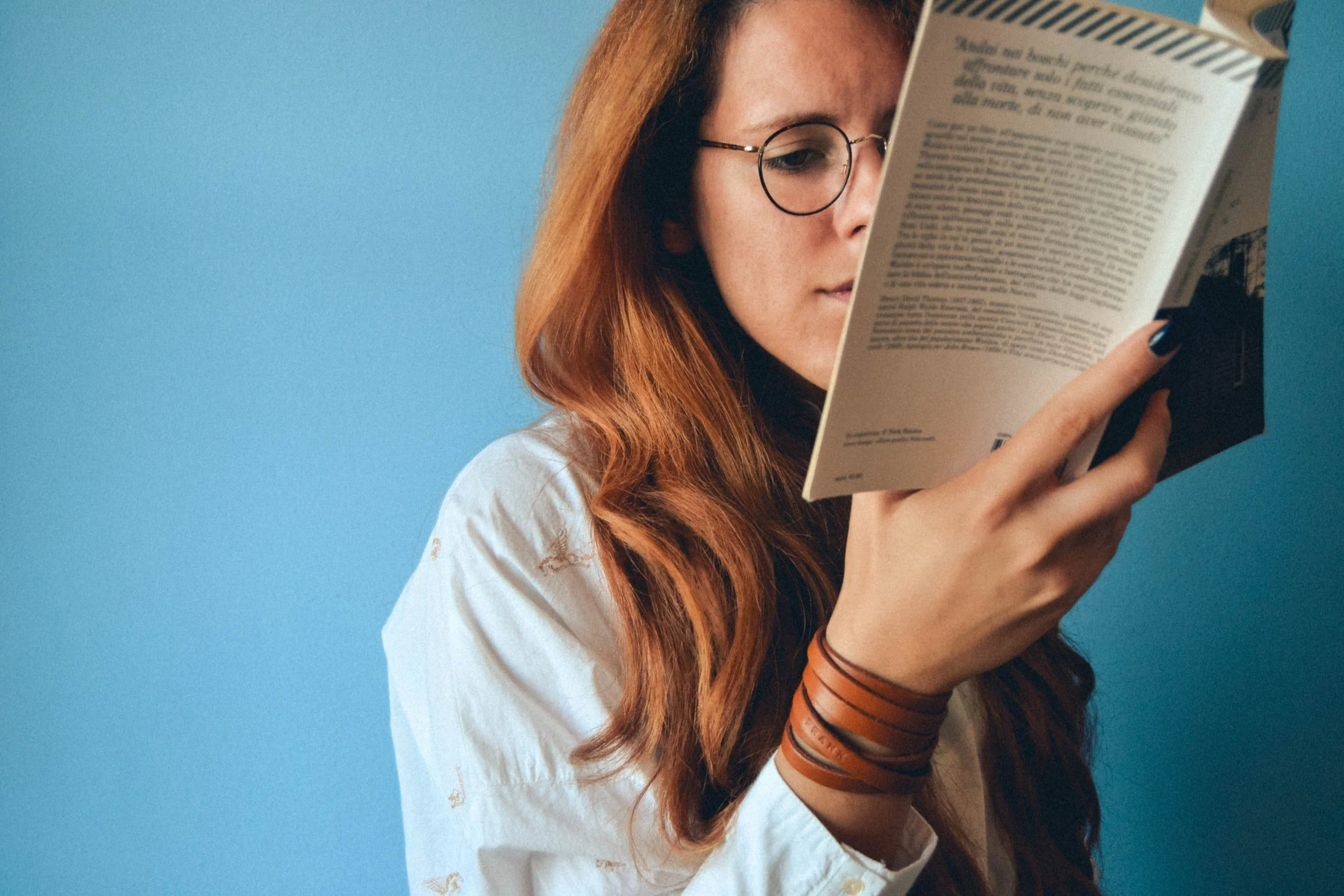 Woman reading a book to stimulate the brain and support neuroplasticity, learning, and cognitive health