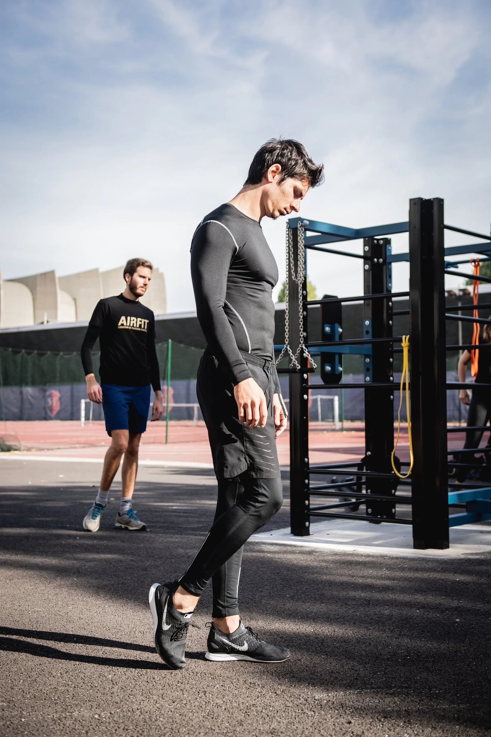Man at outdoor gym with head down looking exhausted and struggling – common sign of low testosterone and male hormone deficiency – Premier Integrative Functional Medicine Tustin California