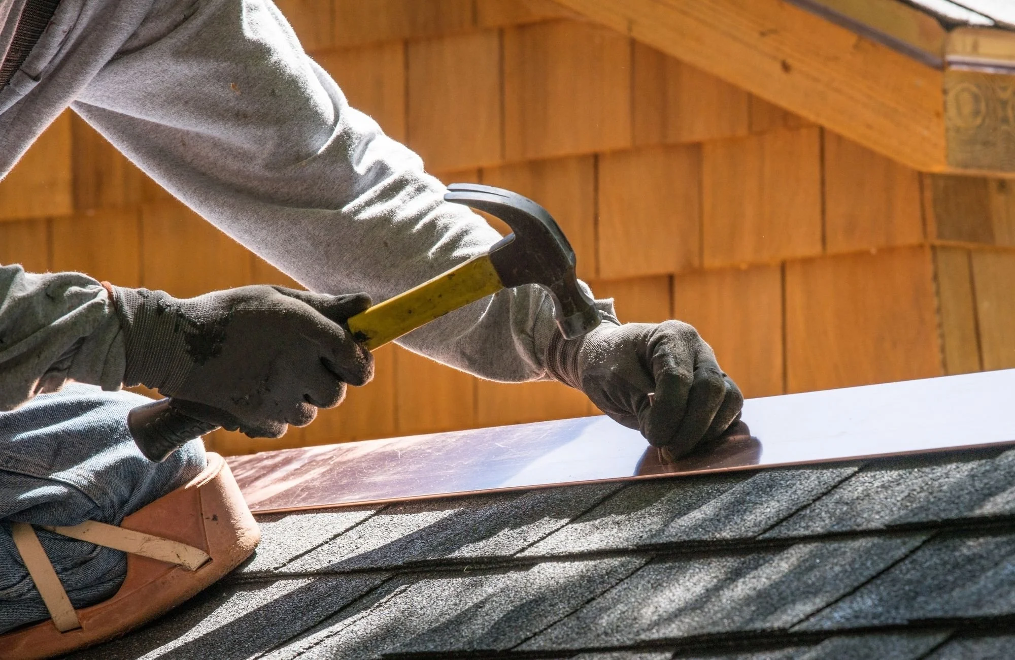 a person installing steel flashings
