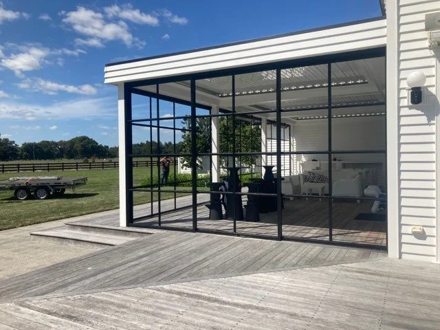 Crittall-style doors leading to an outdoor deck in a rural home