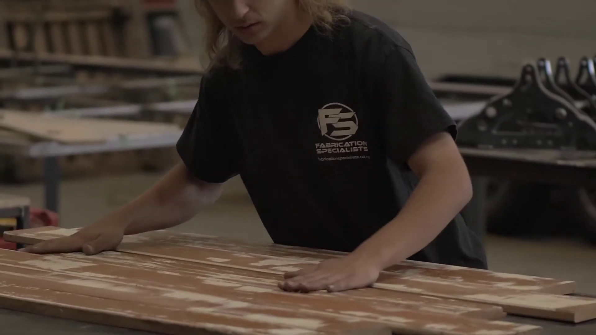 A skilled worked from Fabrication Specialists working on recycled timber
