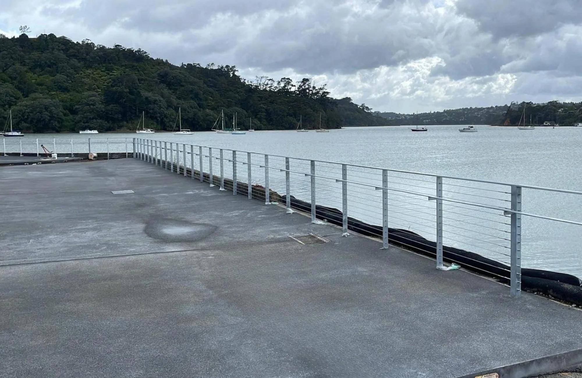 seawall balustrading with yachts in background