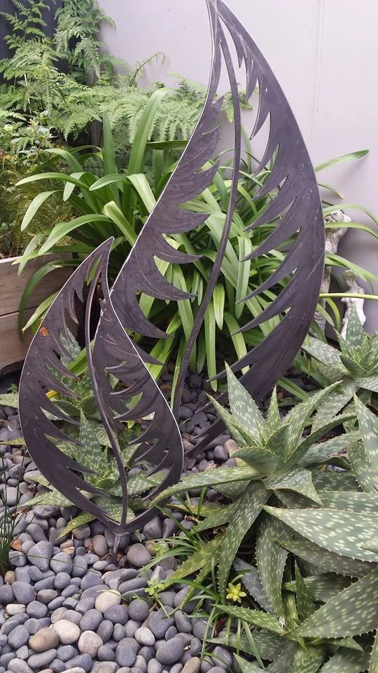 bespoke metal garden art - 2 decorative leaves in a garden setting