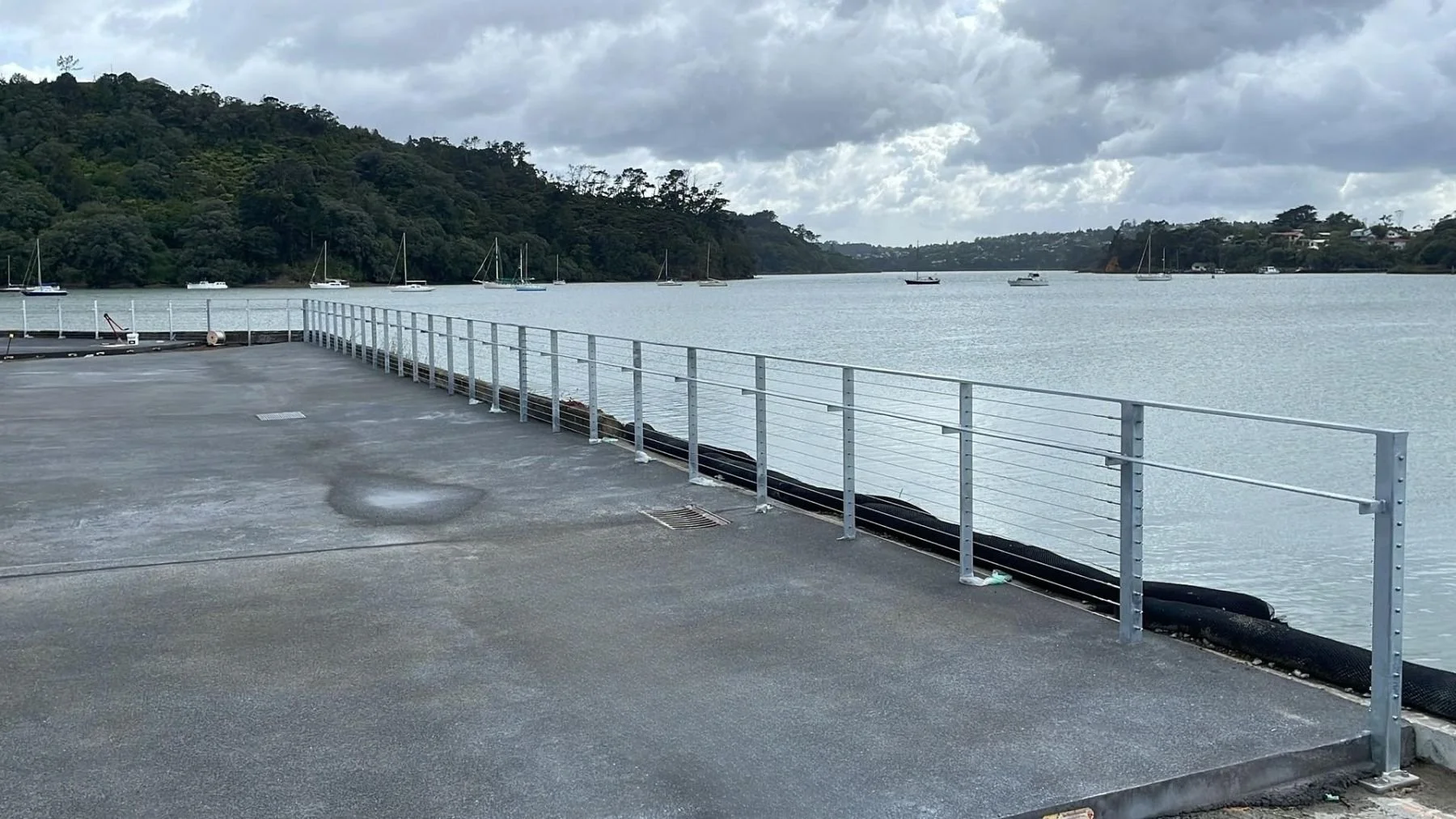 seawall balustrading made from stainless steel at Catalina Bay with yachts in background