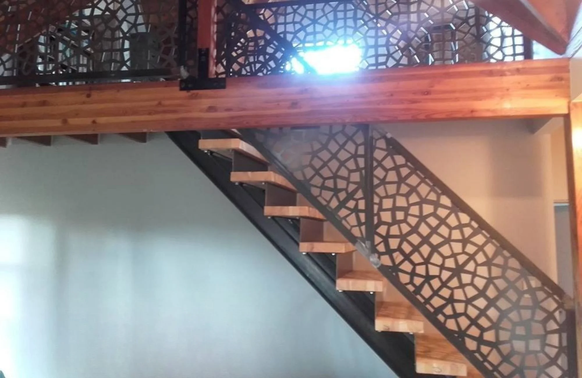 Custom staircase and handrails with decorative steelwork