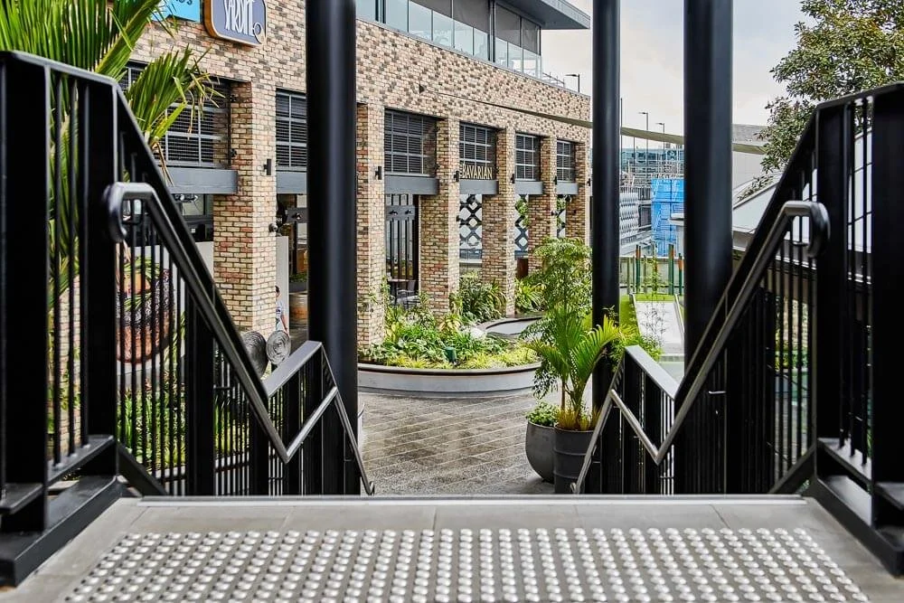 stairs for a commercial centre leading outside with steel handrails and balustrades