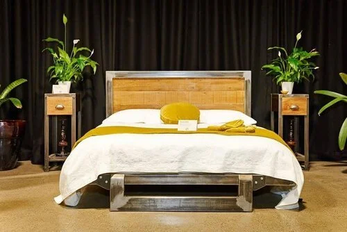 timber and steel bed frame with stylish bedding and decor