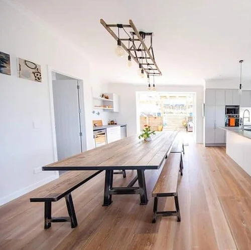 residential long timber and steel table and benchseats for indoors with bespoke ladder lighting above - Stanmore Bay