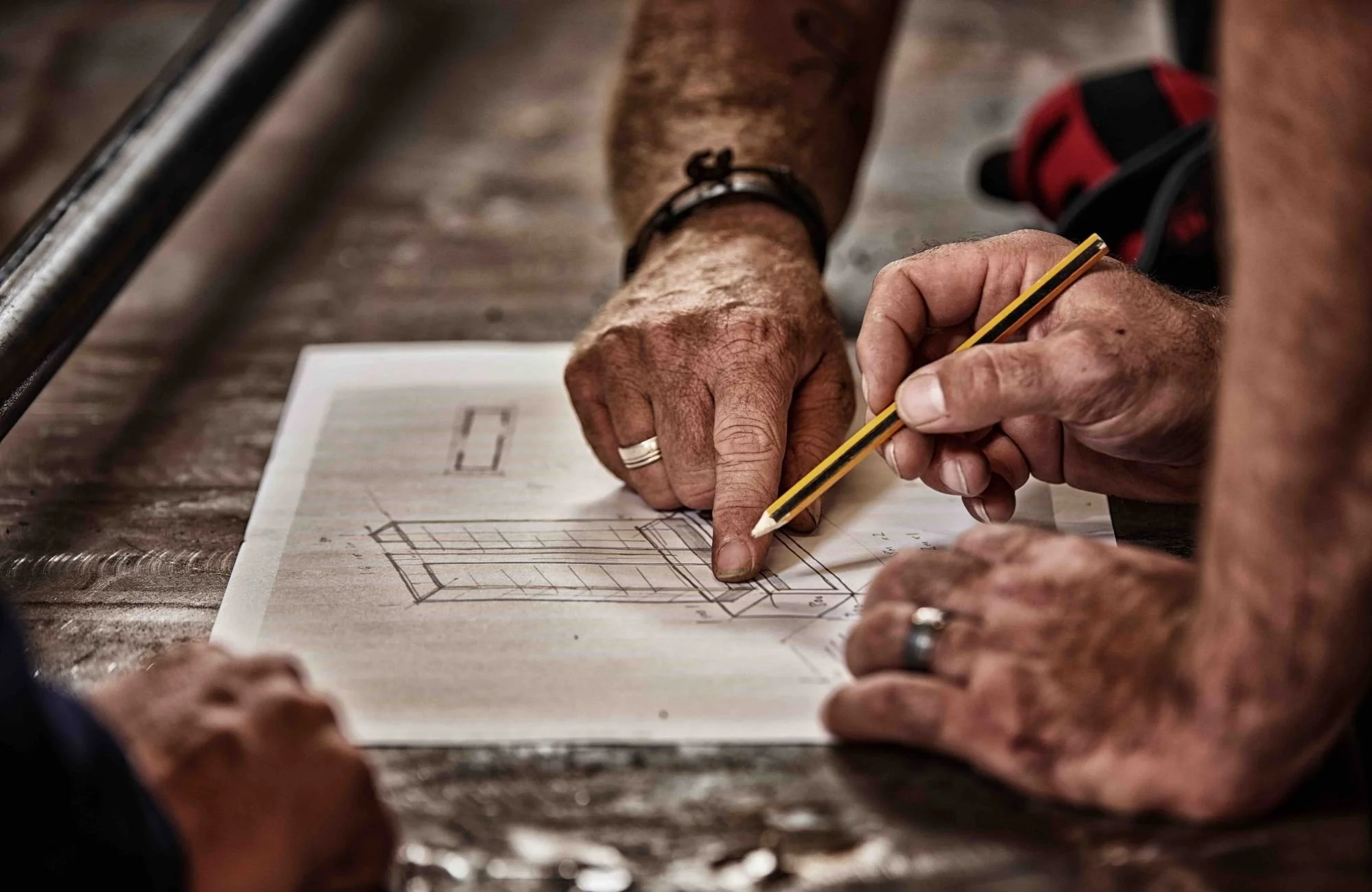 2 people drawing and working out steel design and solutions