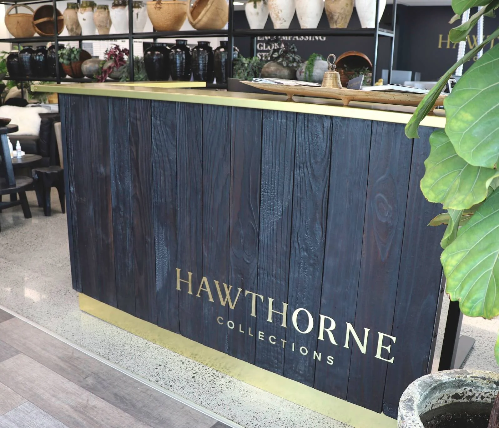 A reception counter with burnt wooden panel (shou sugi ban) in Auckland