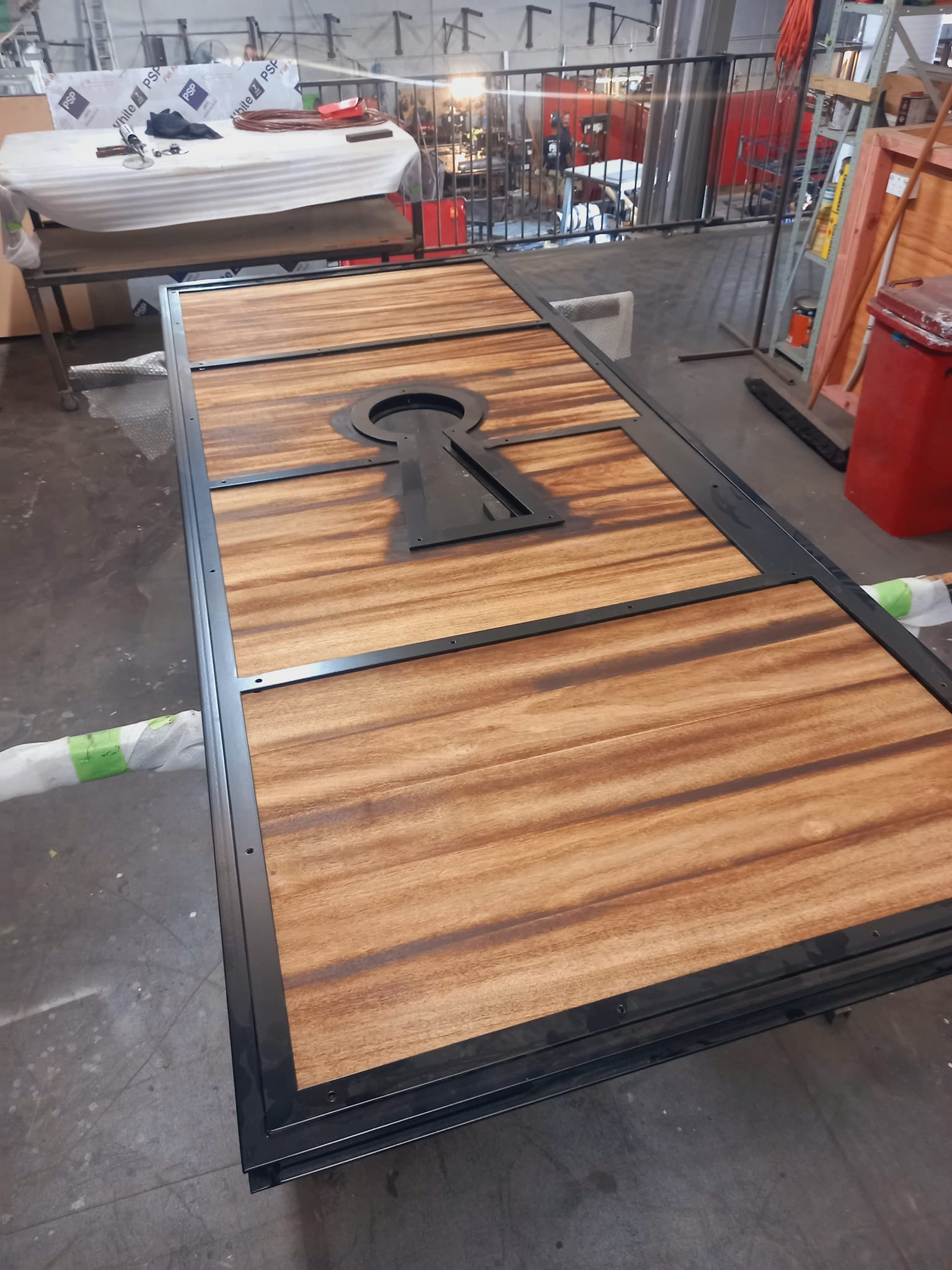 steel-framed timber front door with a huge keyhole shaped window