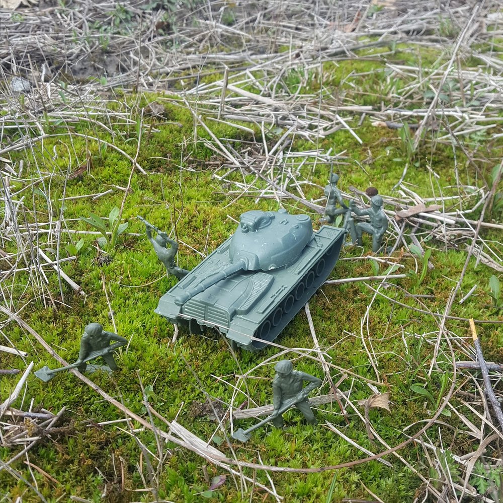 2.. _Play Station, War Games_, 2019. Green Plastic army men and tank, set up on moss on site - Nancy Hart.jpg