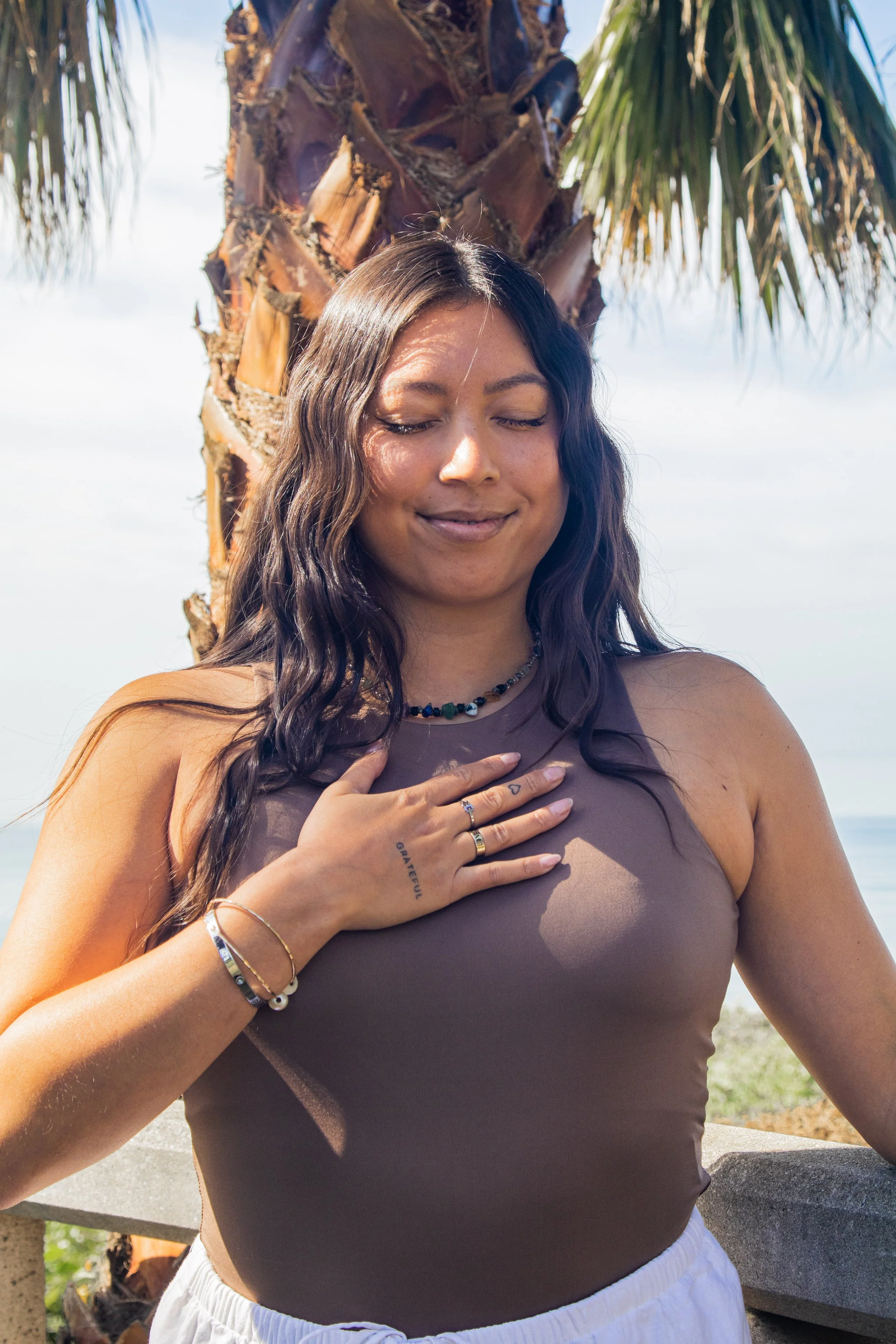 Person playing a purple crystal singing bowl