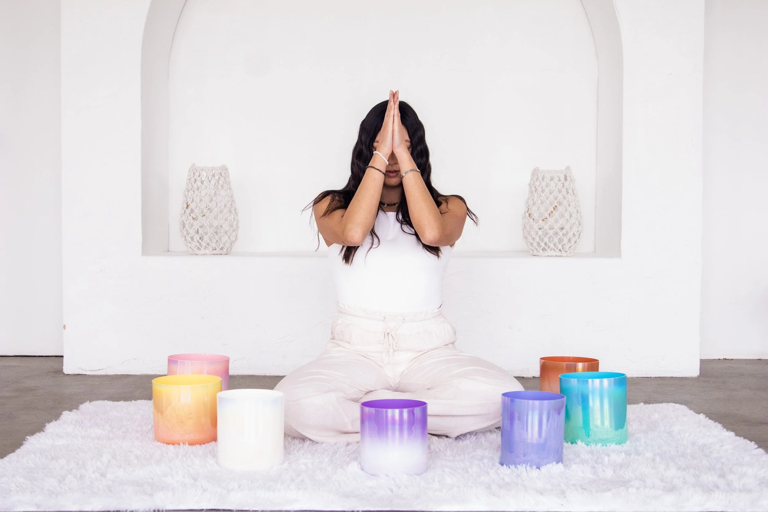 Person playing a purple crystal singing bowl