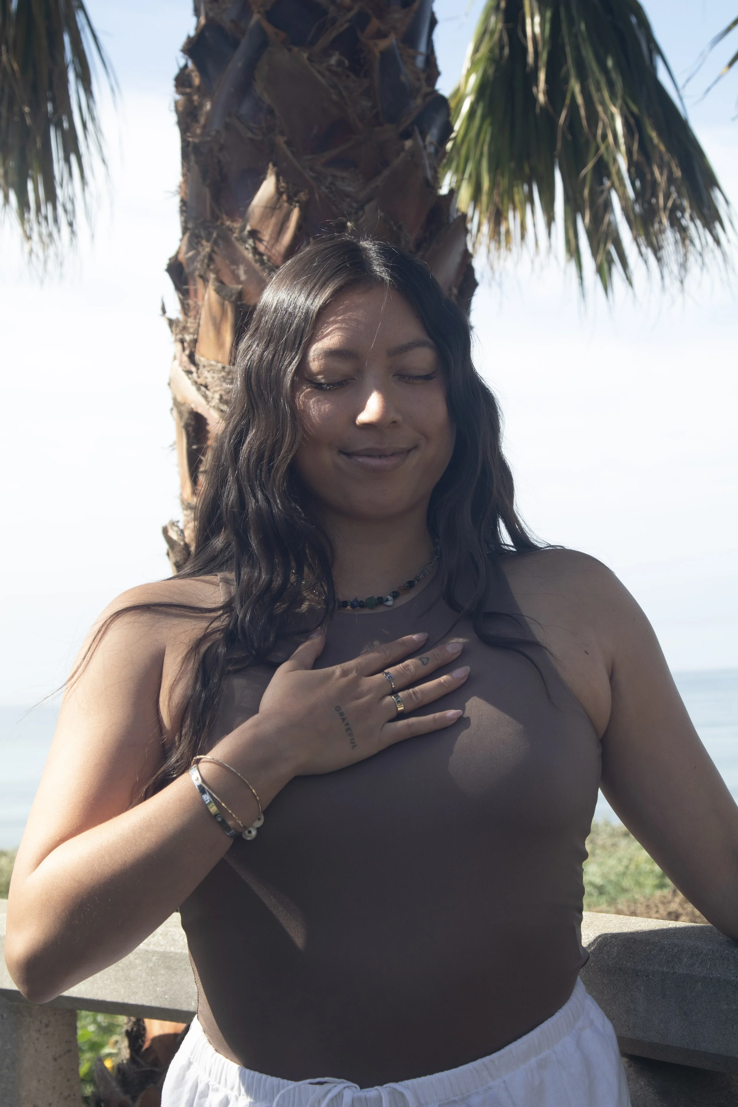 Person playing a purple crystal singing bowl