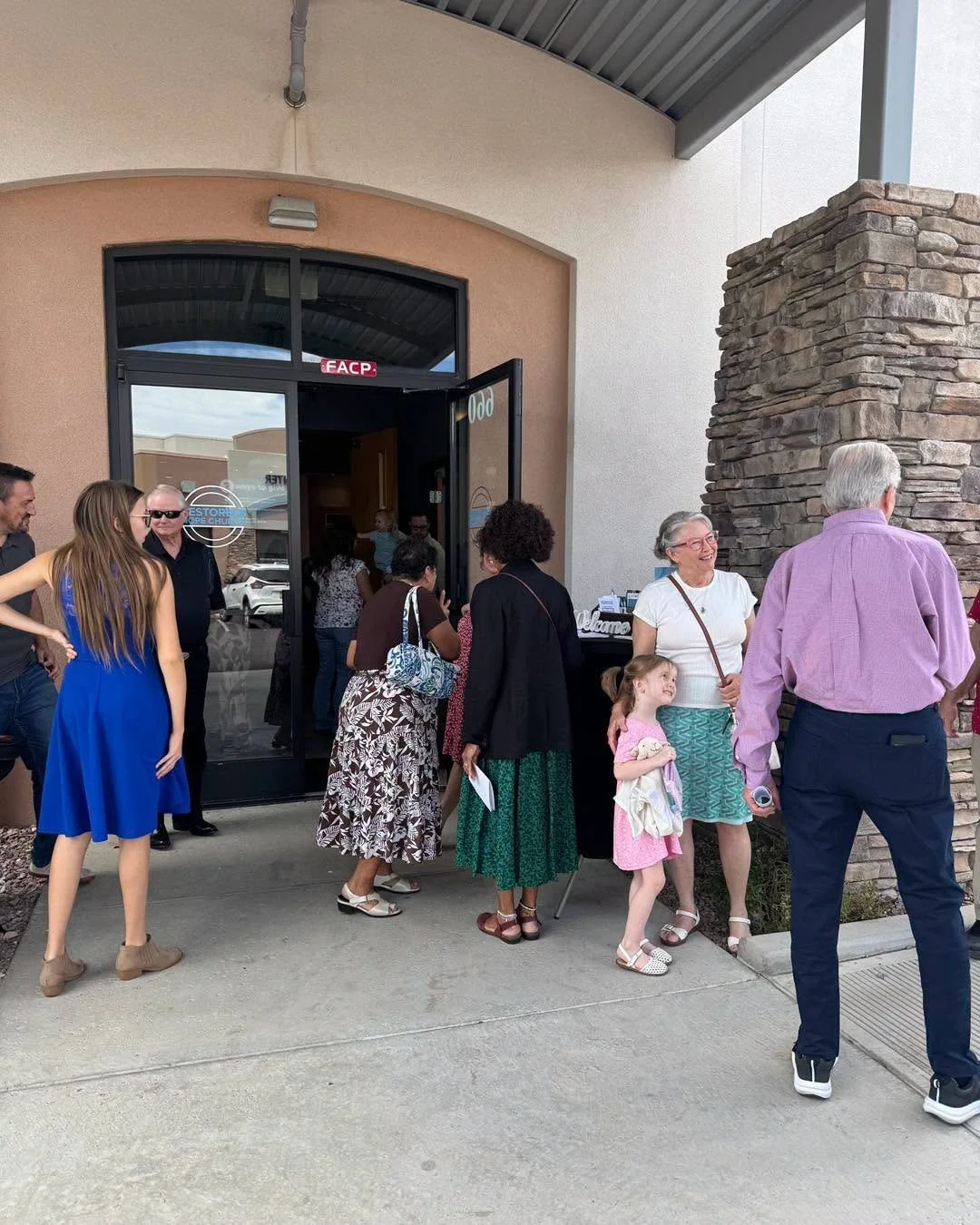 People arriving at Restoring Hope Church on a Sunday morning.