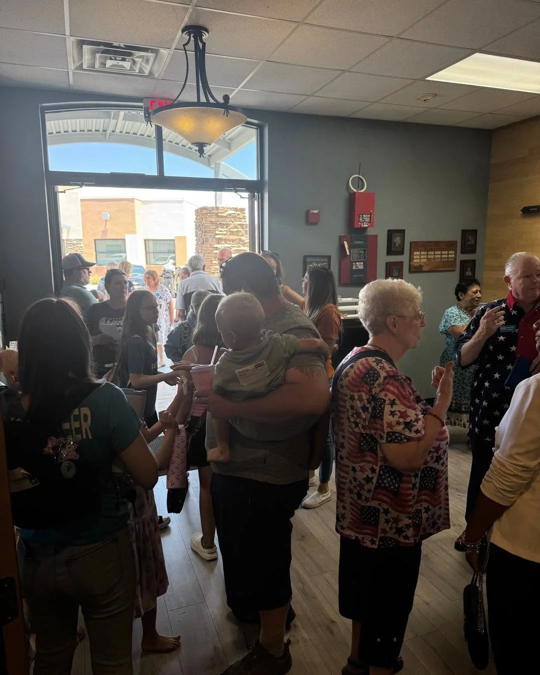 People greeting one another in the Restoring Hope Church lobby.