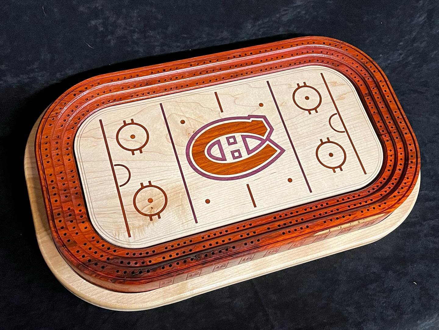 My latest project.  A Montreal Canadians hockey themed cribbage board.  Made from Padauk and Maple with my Legacy Maverick CNC router. The inlay is Padauk and Purple Heart.  The inlay and retired jerseys were done with an Epilog laser.