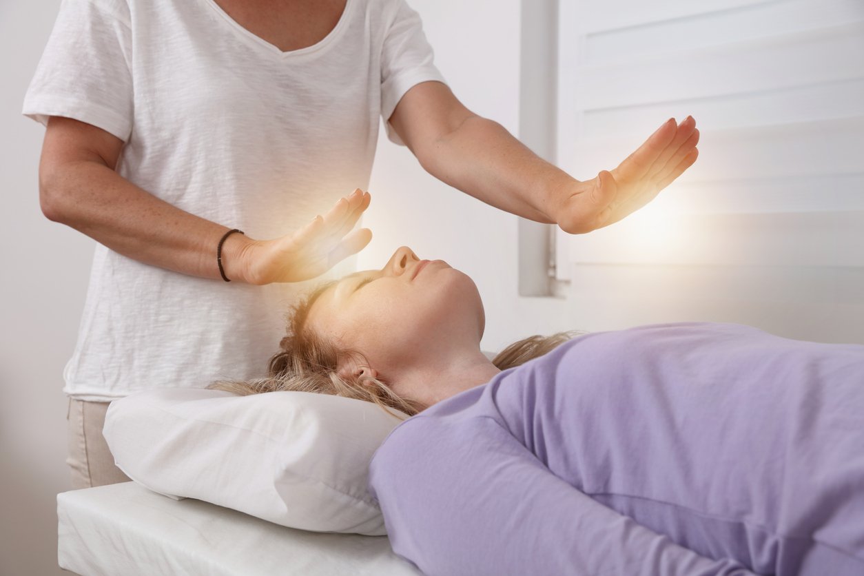 woman receiving Reiki healing session