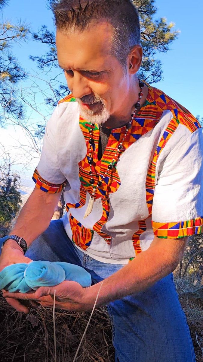 shamanic ceremony on mountain with male practitioner